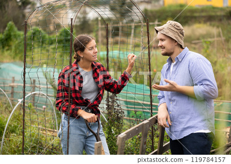 European girl in checkered shirt, chatting sweetly with man neighbor European girl in checkered shirt, chatting sweetly with man neighbor 119784157