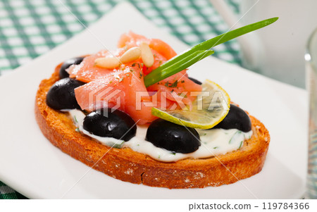 Tasty canape with salmon and olives Tasty canape with salmon and olives 119784366