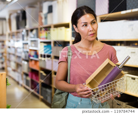 Woman standing at household goods store Woman standing at household goods store 119784744