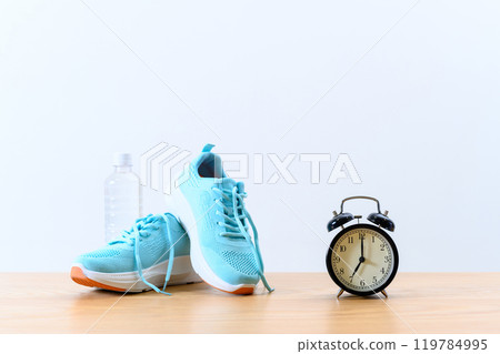 Light blue sneakers, clock and water Background material Background Athletic shoes Light 119784995