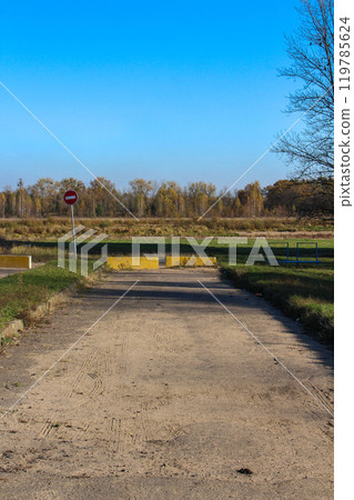 Parking lot fenced with concrete blocks, green area protection 119785624