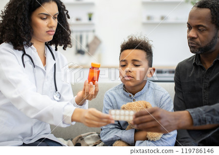 Compassionate female doctor offers medication to concerned child and parent 119786146
