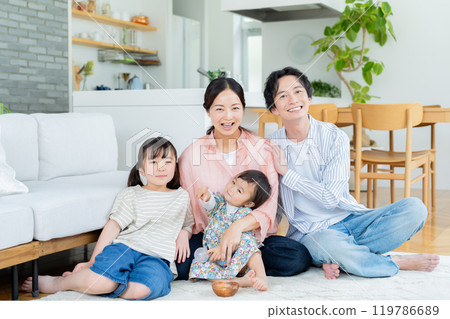 Four people relaxing in the living room 119786689