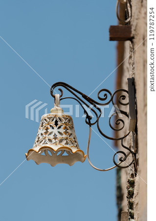 Decorative street lamp and blue sky in Italy 119787254