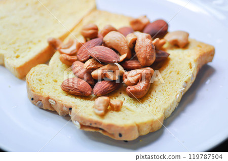 bread , pumpkin bread or sliced bread or a piece of bread with almond and cashew nut topping 119787504