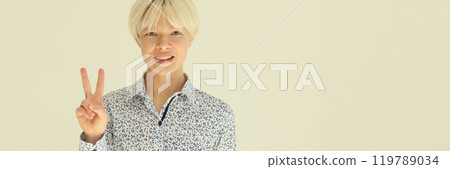 Smiling blonde woman showing victory V sign with fingers 119789034