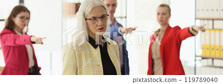 Abusive colleagues blame mature employee in company office 119789040