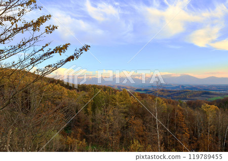 The Tokachi mountain range in Hokkaido in late autumn as the sun sets 119789455