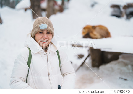 Woman tourist with Cute fox on snow in winter season at Zao fox village, traveler sightseeing Miyagi prefecture. landmark and popular for attraction near Sendai, Tohoku, Japan. Travel and Vacation Woman tourist with Cute fox on snow in winter season at Zao fox village, traveler sightseeing Miyagi prefecture. landmark and popular for attraction near Sendai, Tohoku, Japan. Travel and Vacation 119790070