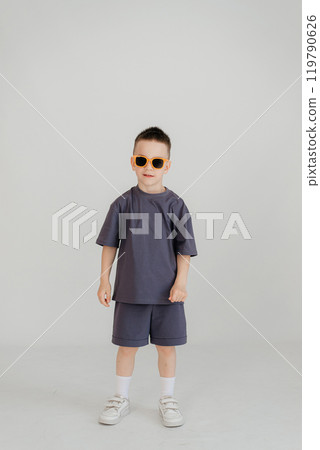 Full body little small smiling happy boy 5-6 years old wearing grey t-shirt look camera isolated on background studio Mother's Day love family lifestyle concept Full body little small smiling happy boy 5-6 years old wearing grey t-shirt look camera isolated on background studio Mother's Day love family lifestyle concept 119790626