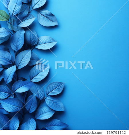 Blue leaves arranged on vibrant blue background create serene and calming atmosphere. composition highlights beauty of nature in monochromatic style 119791112