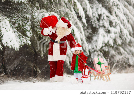 Kids and Santa with Christmas gifts in snow forest Kids and Santa with Christmas gifts in snow forest 119792157