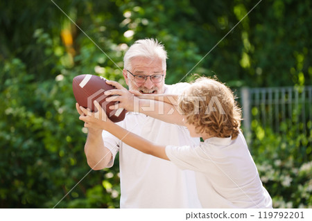 Grandfather and kids in sunny garden 119792201