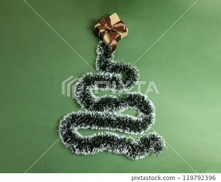 Christmas garland nested in the form of a Christmas tree with a gift box with a brown bow Christmas garland nested in the form of a Christmas tree with a gift box with a brown bow 119792396