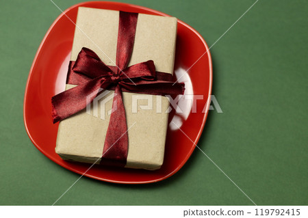 craft gift box on red plate with ribbon craft gift box on red plate with ribbon 119792415