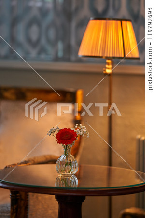 Splendid chandelier with lit candles in a beautiful room of an old mansion 119792693