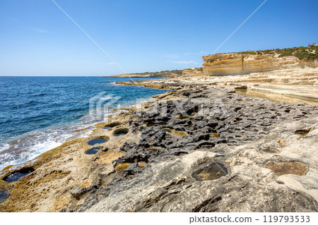 Crystal clear turquoise water in blue lagoon. St. Peters pool - rocky beach at Malta Crystal clear turquoise water in blue lagoon. St. Peters pool - rocky beach at Malta 119793533