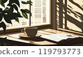 Reading a book while drinking coffee by the window 119793773