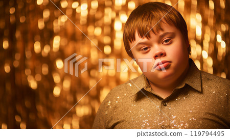 Portrait of smiling laughing teenager guy with Down syndrome golden background. 119794495