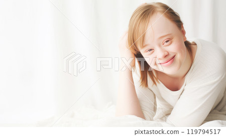 Portrait of smiling laughing teenage girl with Down syndrome white background. 119794517