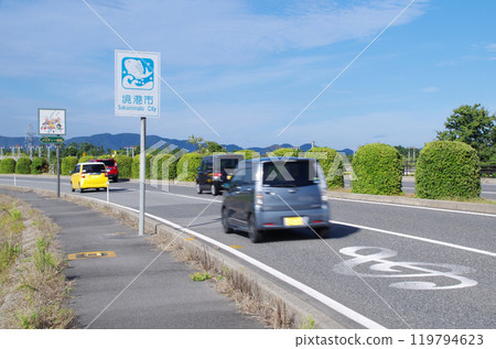 Cars passing one after another on Melody Road along Yonago Kitaro Airport in Sakaiminato City, Tottori Prefecture 119794623