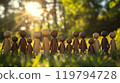 Intricately designed wooden figurines standing together in a sunlit meadow celebrating community 119794728