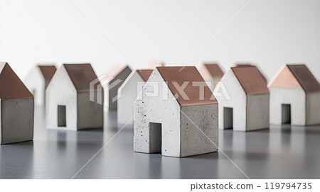 Miniature concrete houses neatly aligned on a smooth tabletop for urban planning presentations 119794735