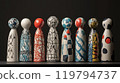 Hand-painted ceramic figurines displayed on a sleek black table against a plain background 119794737