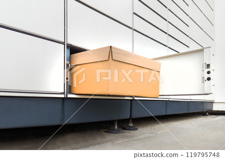Cardboard Box Partially Pulled from Parcel Locker 119795748