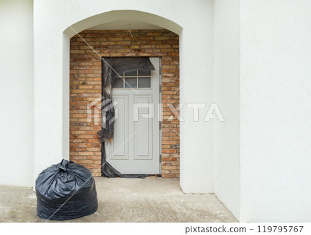 Front Door with Trash Bag After Home Renovation Front Door with Trash Bag After Home Renovation 119795767