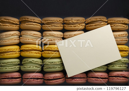macaroons of different colors on a black background 119796127
