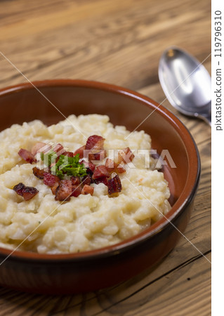 Slovakian halusky served with sheep cheese and roasted bacon Slovakian halusky served with sheep cheese and roasted bacon 119796310