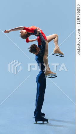 Female skater arched beautifully as her partner lifts her, emphasizing combination of power, grace, and poise in performance. Female skater arched beautifully as her partner lifts her, emphasizing combination of power, grace, and poise in performance. 119796899