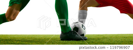 Banner. Close-up shot of two soccer players in green and red uniforms competing for control of ball on grassy field against white studio background. Banner. Close-up shot of two soccer players in green and red uniforms competing for control of ball on grassy field against white studio background. 119796907