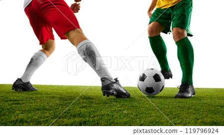 Soccer player in yellow and green uniform evades tackle from opponent in red and white on green soccer stadium against white studio background. Soccer player in yellow and green uniform evades tackle from opponent in red and white on green soccer stadium against white studio background. 119796924