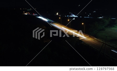 A road emerging in the darkness of the night A road emerging in the darkness of the night 119797568