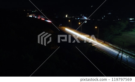 A road emerging in the darkness of the night A road emerging in the darkness of the night 119797569