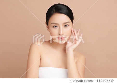 Beautiful young asian woman with clean fresh skin on beige background, Face care, Facial treatment, Cosmetology, beauty and spa, Asian women portrait. 119797742
