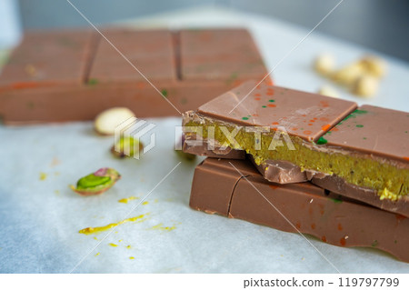 Trend Dubai chocolate with pistachio paste and kataifi dough. Confectionery handmade sweets at home in the kitchen.  119797799