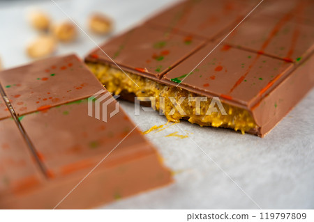 Trend Dubai chocolate with pistachio paste and kataifi dough. Confectionery handmade sweets at home in the kitchen. Trend Dubai chocolate with pistachio paste and kataifi dough. Confectionery handmade sweets at home in the kitchen. 119797809