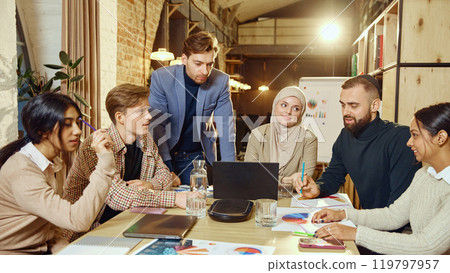 Professionals participate in business planning session, using graphs and charts for effective strategy. Professionals participate in business planning session, using graphs and charts for effective strategy. 119797957