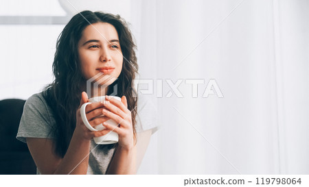 Coffee relax. Home rest. Weekend leisure. Satisfied woman drinking latte enjoying sunny morning warm rays of window copy space. Coffee relax. Home rest. Weekend leisure. Satisfied woman drinking latte enjoying sunny morning warm rays of window copy space. 119798064