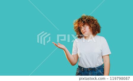 Displeased woman disappointed suspicious expression gesturing isolated on blue empty space background. Displeased woman disappointed suspicious expression gesturing isolated on blue empty space background. 119798087
