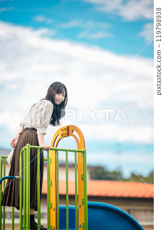 Young woman having fun on a slide Young woman having fun on a slide 119798938