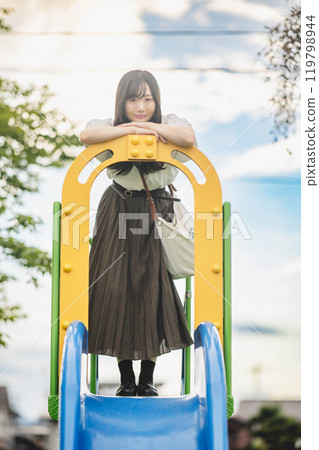 Young woman having fun on a slide 119798944