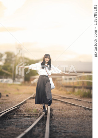 A woman walking on an abandoned railway line 119799193