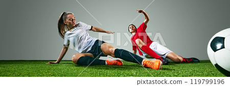 Dynamic image of two young women, soccer players in white and red jerseys, competing on field, showing skills and motivation to win. 119799196