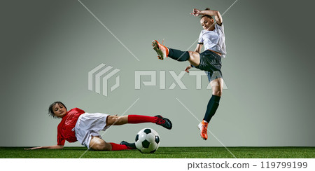 Rainy weather training session. Powerful action of two female soccer players in middle of intense play. 119799199