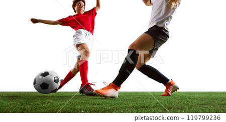 Dynamic soccer game between two determined female athletes in red and white uniforms on lush green field. Dynamic soccer game between two determined female athletes in red and white uniforms on lush green field. 119799236