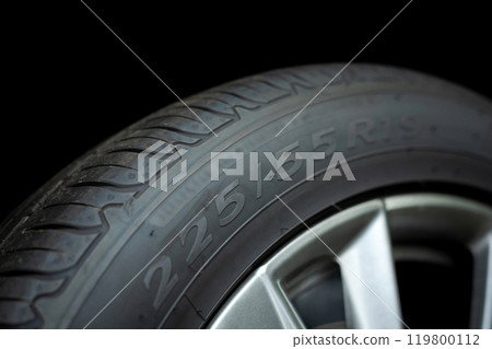 Numbers on the car tire sidewall, emphasizing the importance of checking wheel and tire specifications before travel. Highlights tire safety and readiness for the journey 119800112